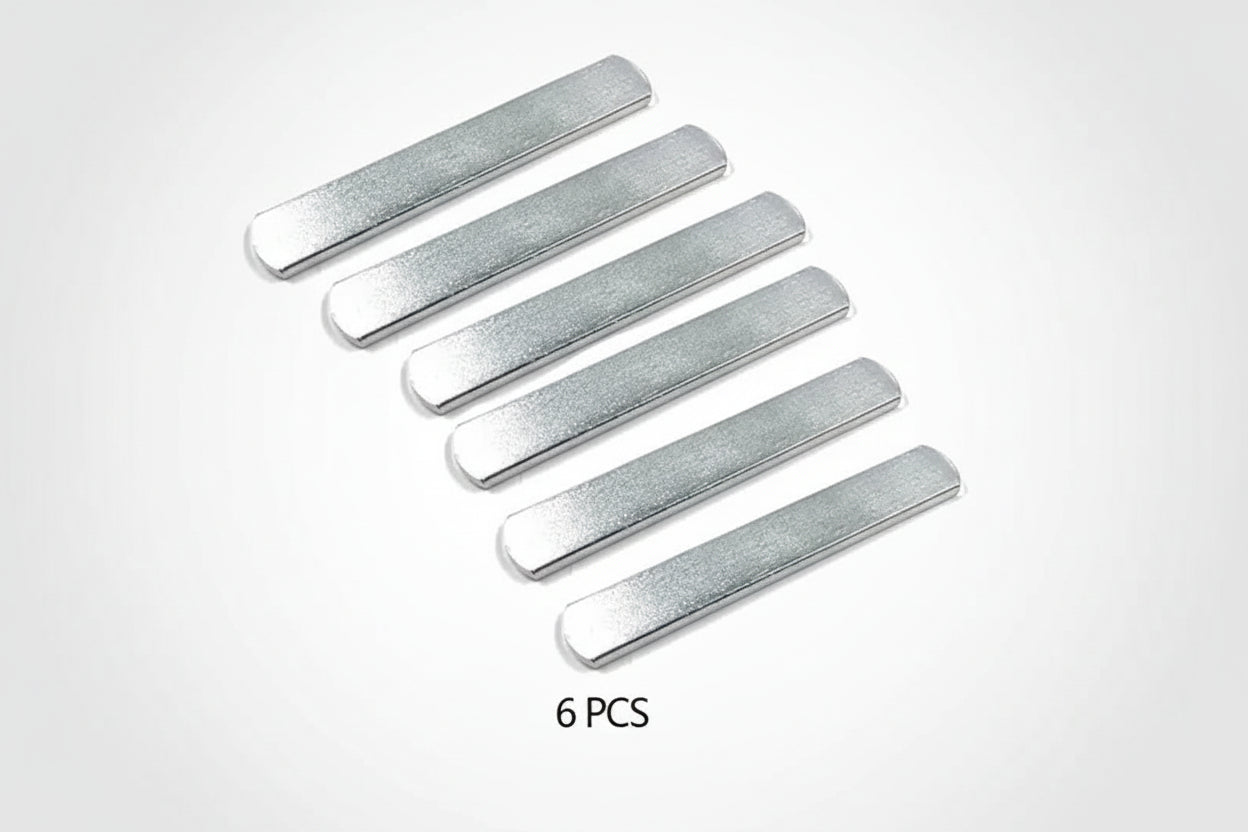 Six silver metal strips on a white background